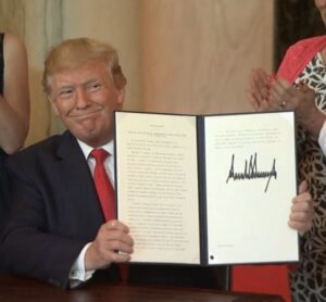 Trump showing a document