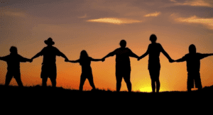 Family holding hands in sunset